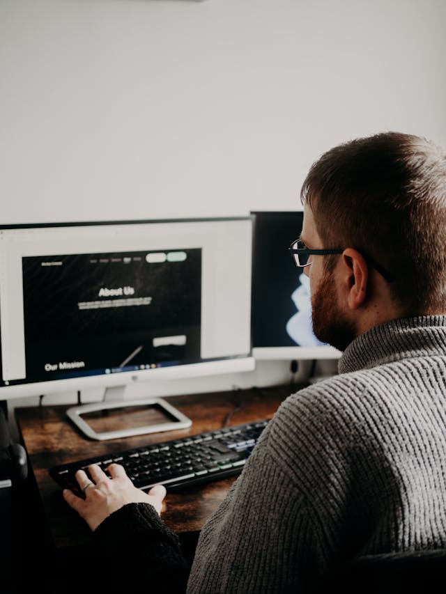 designer at computer working on building a construction website